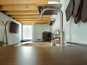 a kitchen sink with a faucet in a kitchen at BRE Apartments - Lumen in Vicenza +8 photos