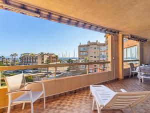 a balcony with chairs and a view of the ocean at Apartment Les Regates-1 by Interhome in Hyères