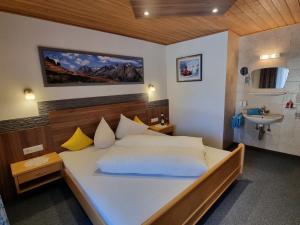 a bedroom with a large bed and a sink at Holiday Home Vesul by Interhome in Kappl