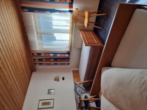 a small room with a bed and a window at Holiday Home Vesul by Interhome in Kappl