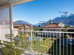 a balcony with a table and chairs and mountains at Apartment Le Lac by Interhome in Gravedona