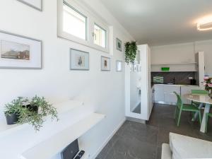 a kitchen and living room with white walls and a table at Apartment Le Lac by Interhome in Gravedona