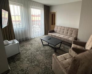 a living room with a couch and a coffee table at Keta in Marijampolė