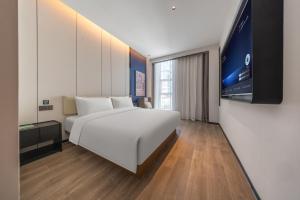 Un pat sau paturi într-o cameră la Atour Hotel Kunming Vientiane City Tuodong Gymnasium