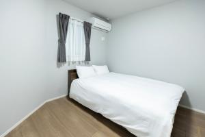Postel nebo postele na pokoji v ubytování 堅粕汐風 K Ocean Breeze