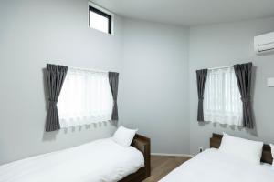 Postel nebo postele na pokoji v ubytování 堅粕汐風 K Ocean Breeze