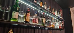 a bar with many bottles and glasses on a shelf at Ferma Art hotel boutique in Baku