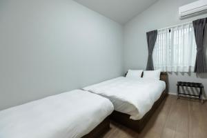 Postel nebo postele na pokoji v ubytování 堅粕汐風 K Ocean Breeze