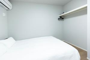 Postel nebo postele na pokoji v ubytování 堅粕汐風 K Ocean Breeze