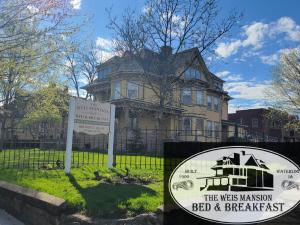 a house with a sign in front of it at The Weis Mansion Bed and Breakfast in Waterloo