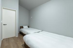 Postel nebo postele na pokoji v ubytování 堅粕汐風 K Ocean Breeze