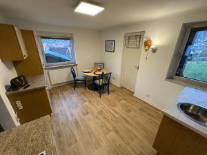 a kitchen with a table and a dining room at Ferienwohnung Am Kirschbaum Mömlingen in Momlingen +3 photos
