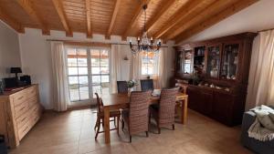 a dining room with a wooden table and chairs at EifelChalet Niederehe in Niederehe
