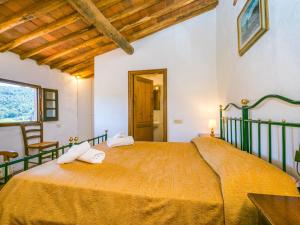 a bedroom with a large bed with towels on it at Apartment Colombaia by Interhome in Lucolena in Chianti