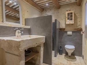 a stone bathroom with a sink and a toilet at Holiday Home Côté Place by Interhome in Villars