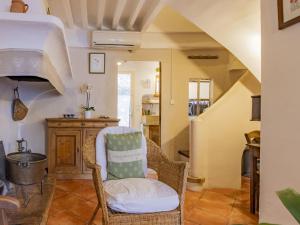 a living room with a chair and a staircase at Holiday Home Côté Place by Interhome in Villars +11 photos