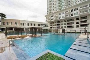 a large swimming pool in front of a building at Solinea Towers in Cebu City