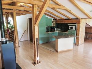 a kitchen with green cabinets and a wooden floor at Apartment Cresta - SAV125 by Interhome in Savognin
