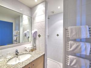a bathroom with a sink and a mirror at Apartment Reine Marine- T2 SUD by Interhome in Saint Malo +15 photos