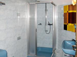 a shower in a bathroom with a blue sink at Apartment Haus Quelle-1 by Interhome in Saas-Grund