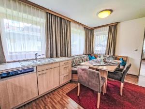 a kitchen with a table and a dining room at Apartment Rosa-2 by Interhome in Mayrhofen +21 photos
