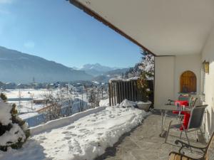 a room with a balcony with snow on the ground at Apartment Schumellins - LAA400 by Interhome in Laax