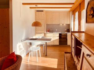 a kitchen with a table and chairs in a room at Apartment Schumellins - LAA400 by Interhome in Laax +27 photos