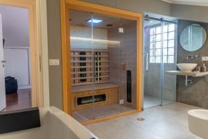 a bathroom with a shower with a tub and a sink at gandino apartment in Rome +4 photos