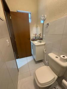 a bathroom with a toilet and a sink at Torquato Flats Orla in Petrolina