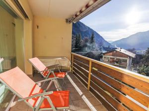 a balcony with chairs and a view of a mountain at Apartment Cristal-4 by Interhome in Leukerbad +3 photos