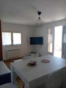 a living room with a white table and chairs at appartement confortable in Sainte-Croix-de-Verdon