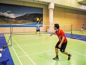 two people playing tennis on a tennis court at Apartment Cristal-4 by Interhome in Leukerbad