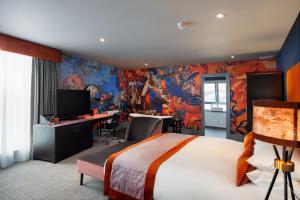 a hotel room with a bed and a painting on the wall at Malmaison Aberdeen in Aberdeen