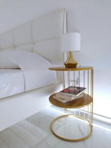 a gold side table in a bedroom with a bed at LianHome b&b "Volte" in Lucera +36 photos