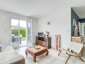 a living room with a couch and a coffee table at Holiday Home Le Bas d'Anville by Interhome in Étaules