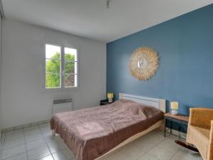 a bedroom with a bed and a window at Holiday Home Le Bas d'Anville by Interhome in Étaules