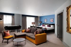 a living room with a couch and a bedroom at Malmaison Aberdeen in Aberdeen