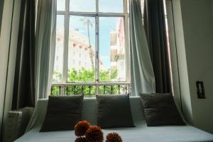 a couch sitting in front of a large window at Casa San Roque in Seville