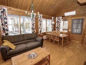 a living room with a couch and a table at Holiday Home Selja 5 by Interhome in Isnäs
