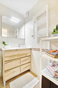 a white bathroom with a sink and a mirror at Home&Holiday Andalisa in Torrevieja +25 photos