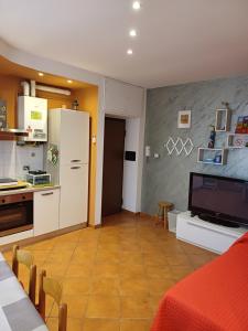 a living room with a kitchen with a refrigerator at PINK & GREEN APARTMENTS - RHO FIERA MILANO MIND - Andrea in Rho