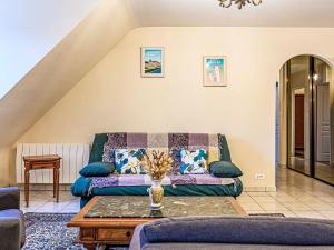 a living room with a couch and a table at Apartment Le Prat-2 by Interhome in Guidel