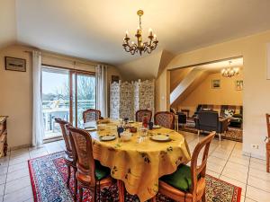 a dining room with a table and chairs at Apartment Le Prat-2 by Interhome in Guidel