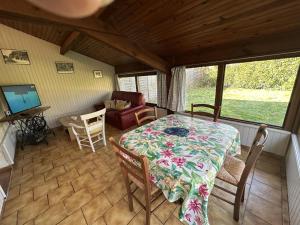 a dining room with a table and chairs in a room at Lagrange in Saint-Perdon