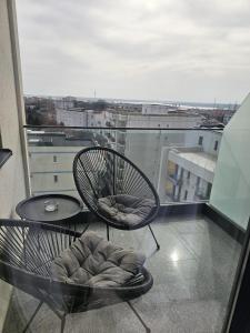 a balcony with a chair and a table on a building at Studio 126 in Eforie Nord