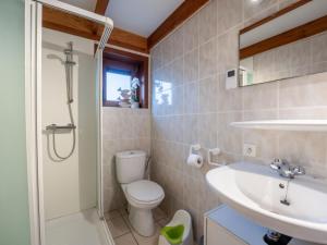 a bathroom with a toilet and a sink at Holiday Home Pippa with parking & garden by Interhome in De Haan