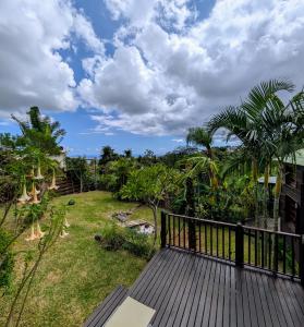 a view from the deck of a house at Villa Créole avec Jacuzzi à la Rivière in La Rivière +15 photos