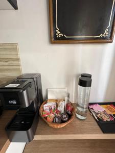 a coffee maker and a basket of food next to a coffee maker at Palmina's Apartments in Brindisi