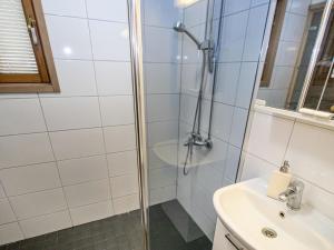 a bathroom with a shower and a sink at Holiday Home Puolukka 2 by Interhome in Isnäs +7 photos