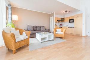 a living room with a couch and chairs and a table at Apprtementhaus Victoria - WE B 06 - Stranddüne in Sassnitz